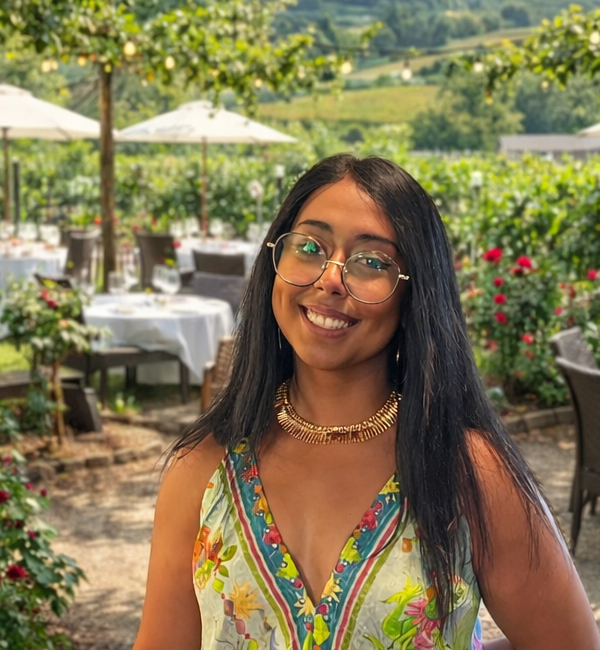 Vanessa Cuevas smiling at a vineyard